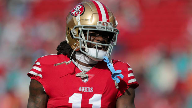 49ers wide receiver Brandon Aiyuk yells in between plays during a game.